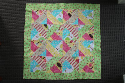 On this blanket I chose the green with little pink flowers for the first border. Sew on the top and bottom first and then the edges. Make sure to slightly stretch the material as you sew. This makes it easier for the quilt to keep shape, and for the top stitching later on.