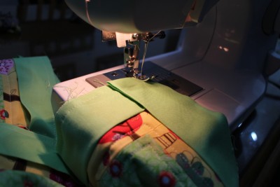 Turn the cloth around and fold the binding to have a straight edge along the top, then just recommence sewing the seam.